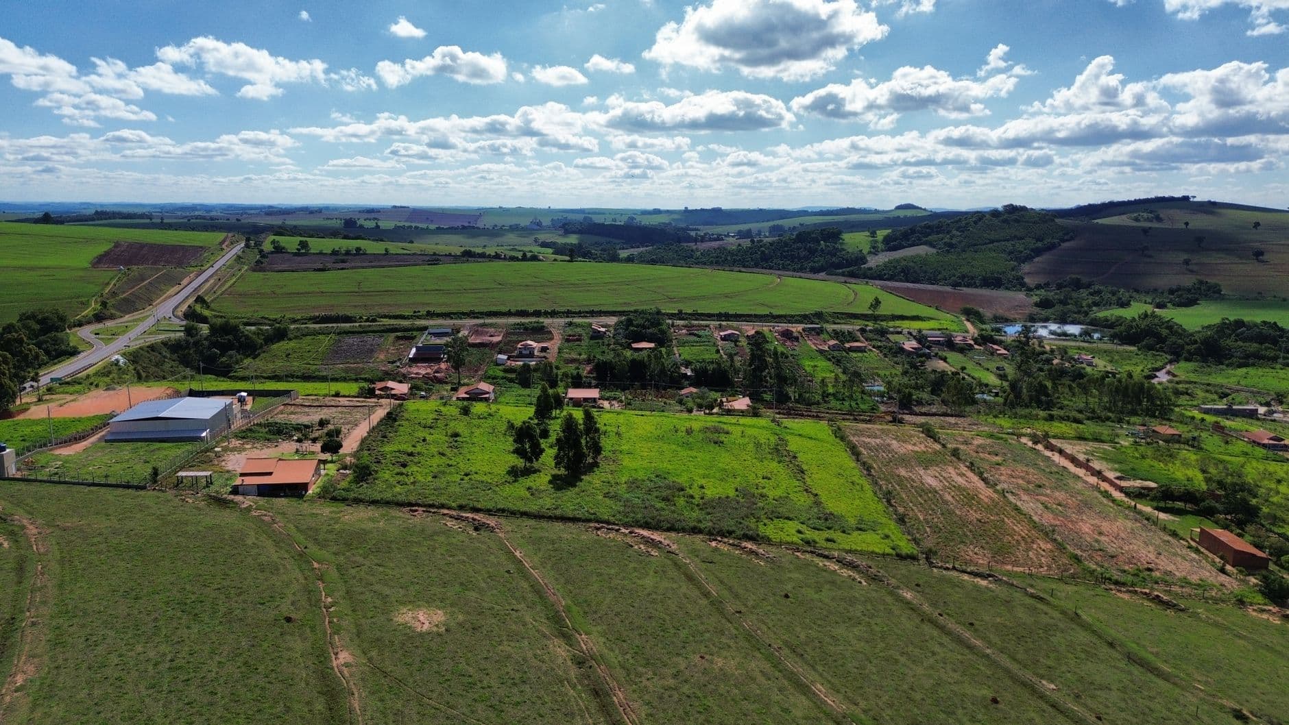 Breathtaking aerial view of lush green fields and farms in the Brazilian countryside.